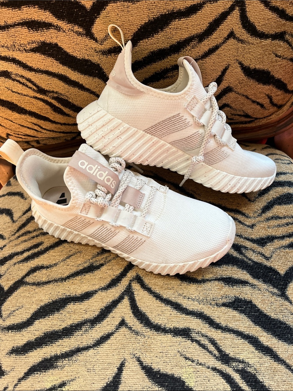 These are Adidas Women's Kaptir Flow sneakers in an off-white and beige colorway